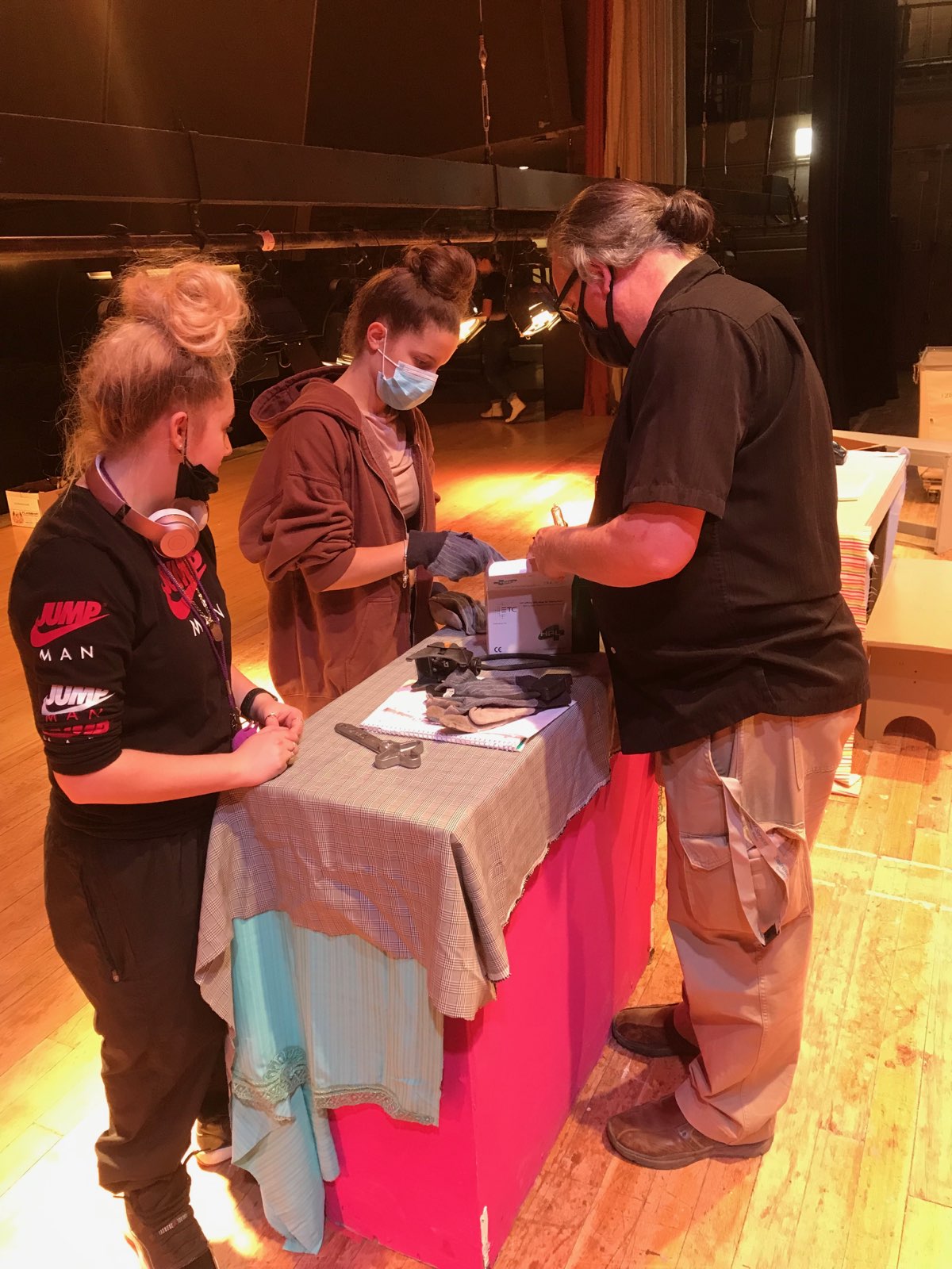 This is a photo of two crew members and a teacher working on a set piece for the Henninger spring musical.