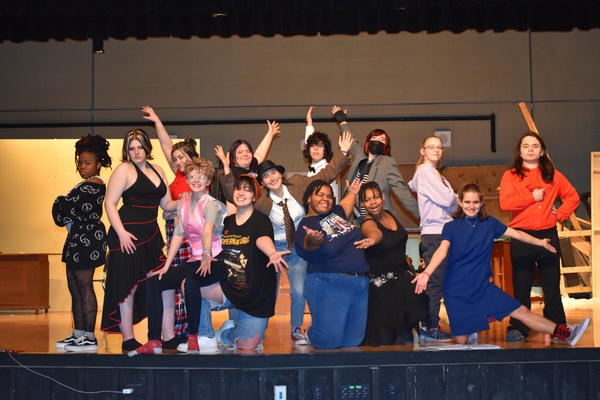 This is a photo of the cast of Corcoran's spring musical, all posing on the school's stage.