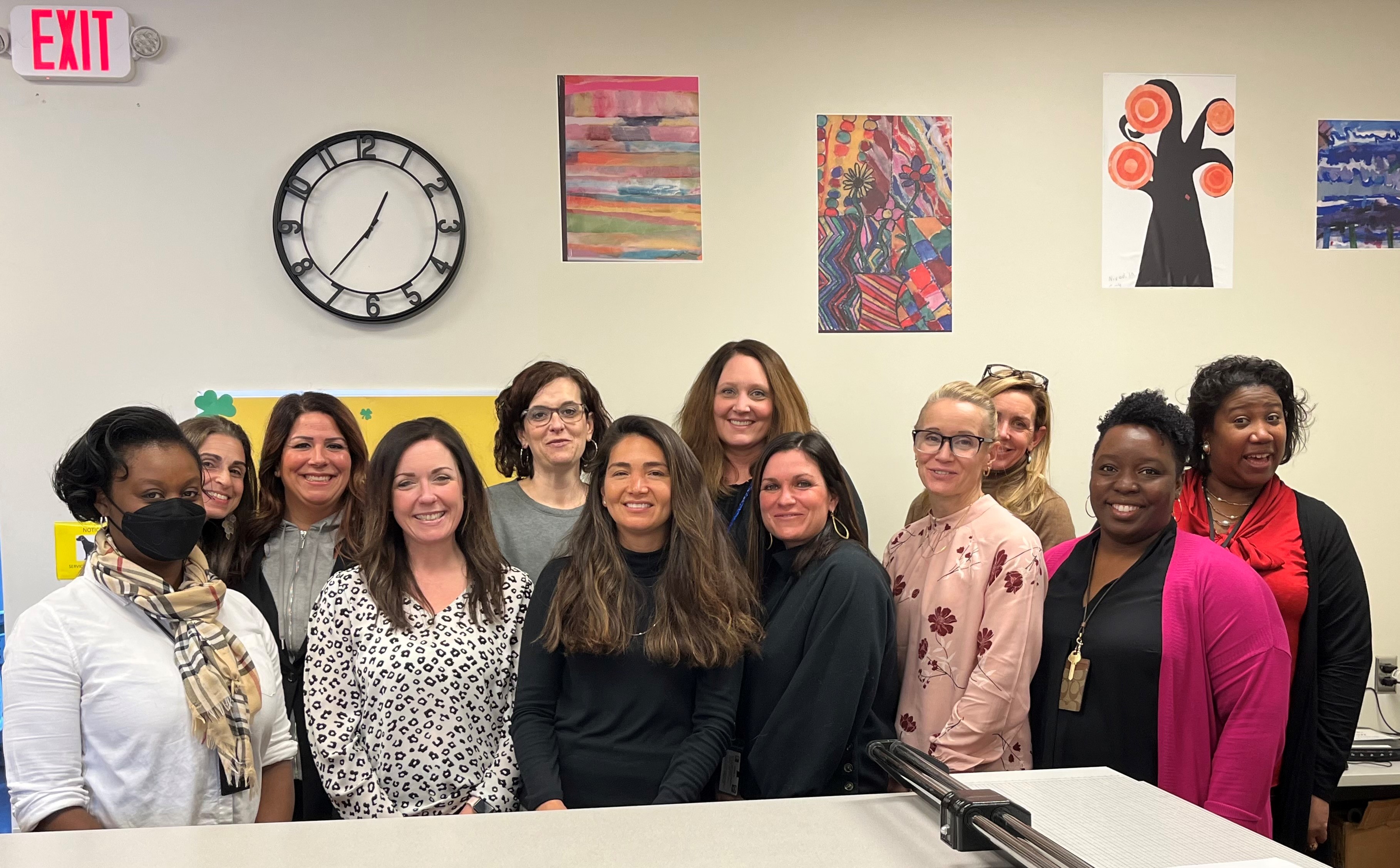 This is a photo of SCSD Impact Coaches, standing in a line, smiling at the camera.