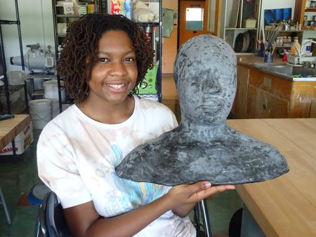 This is a photo of Nottingham student Amiah Crisler holding a mold she made through the Summer Arts Intensive.