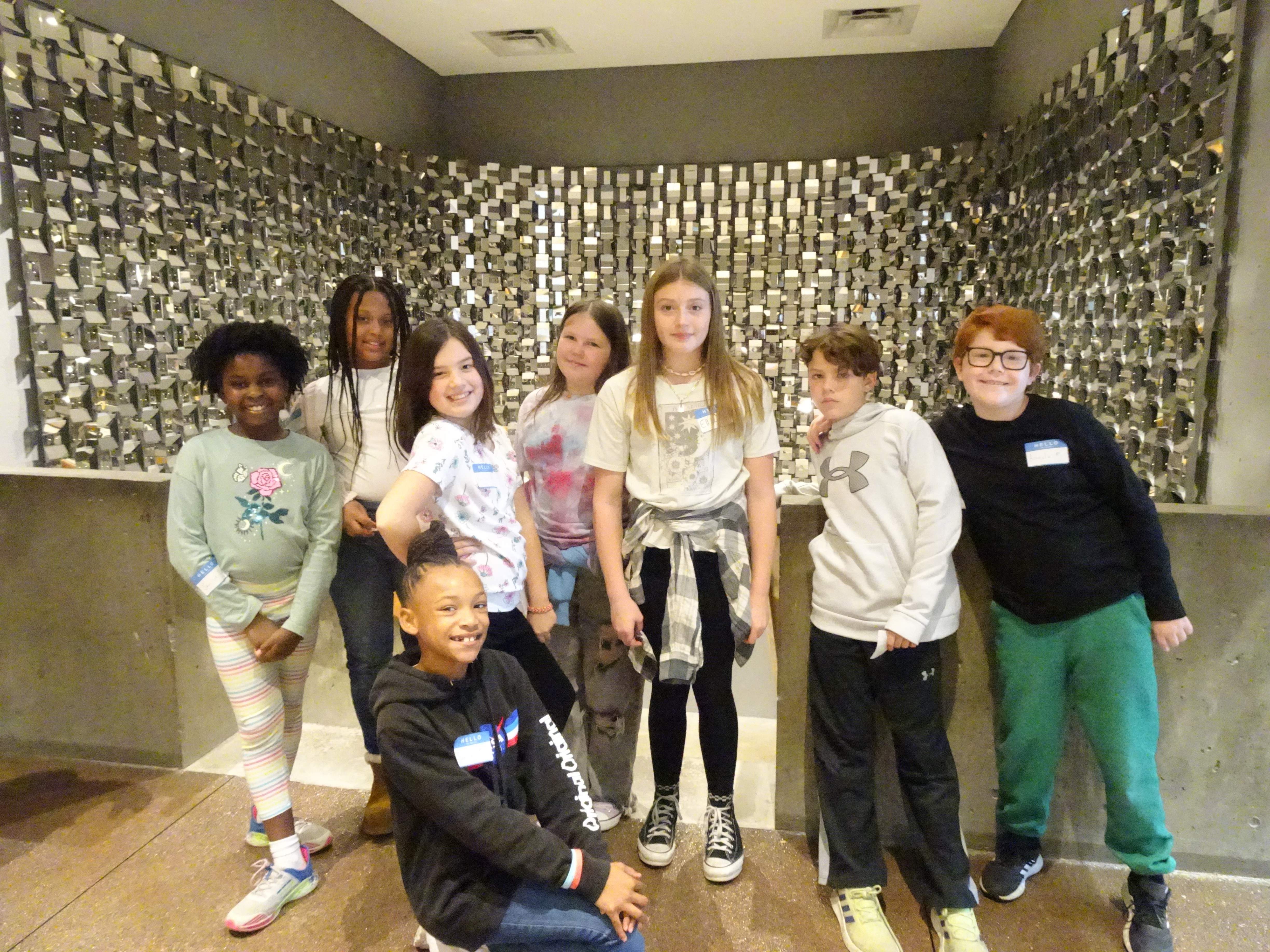 This is a photo of a group of Syracuse Latin students standing in front of a staircase at the Everson Museum of Art.