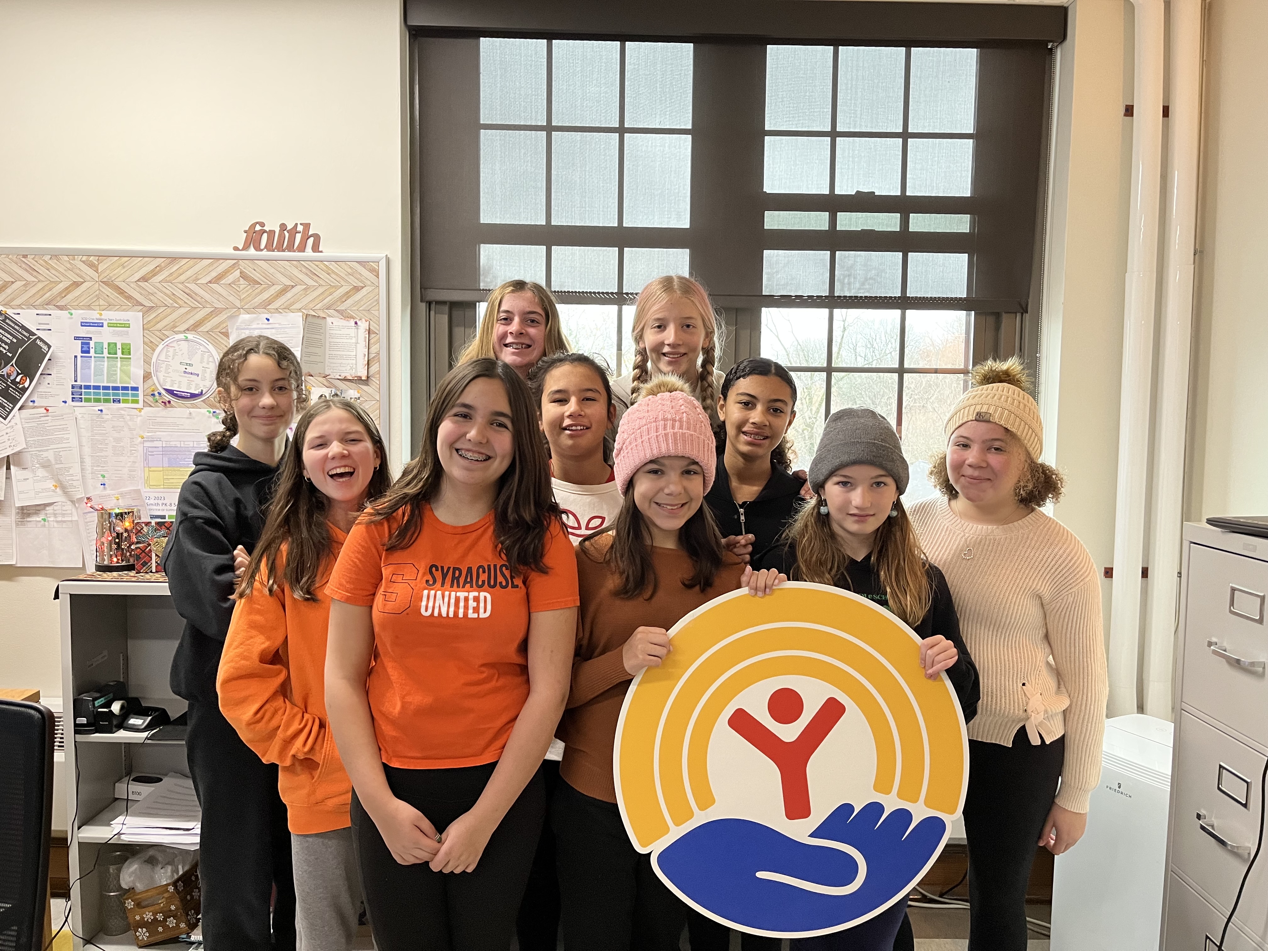 This is a photo of Ed Smith students posing with a United Way sign.