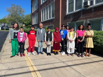 This is a photo of Porter Elementary School students, standing outside their school building lined up and smiling at the camera.