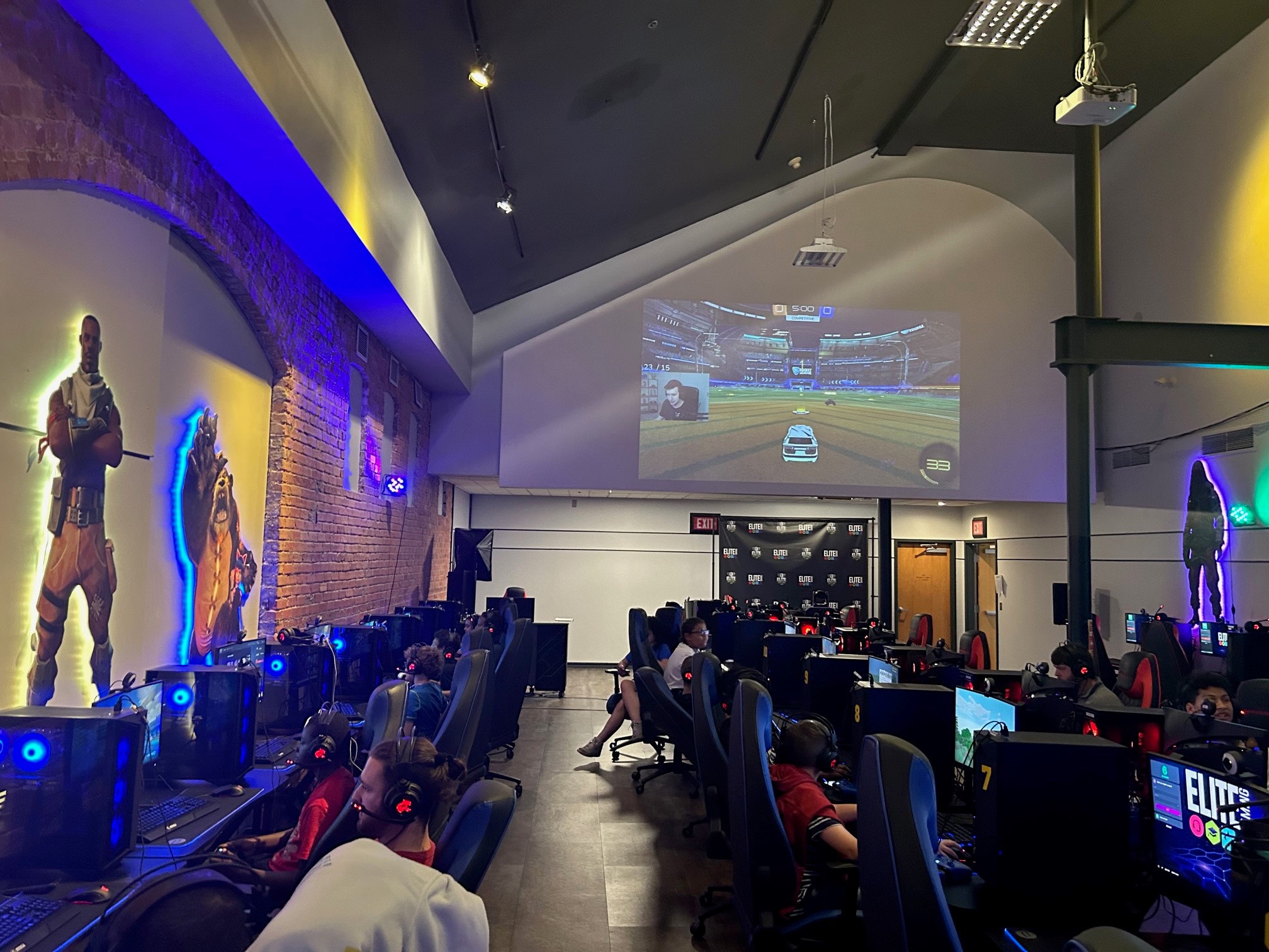 This is a photo of the inside of the Elite Gaming arena, showing rows of computers and students sitting at some of them.