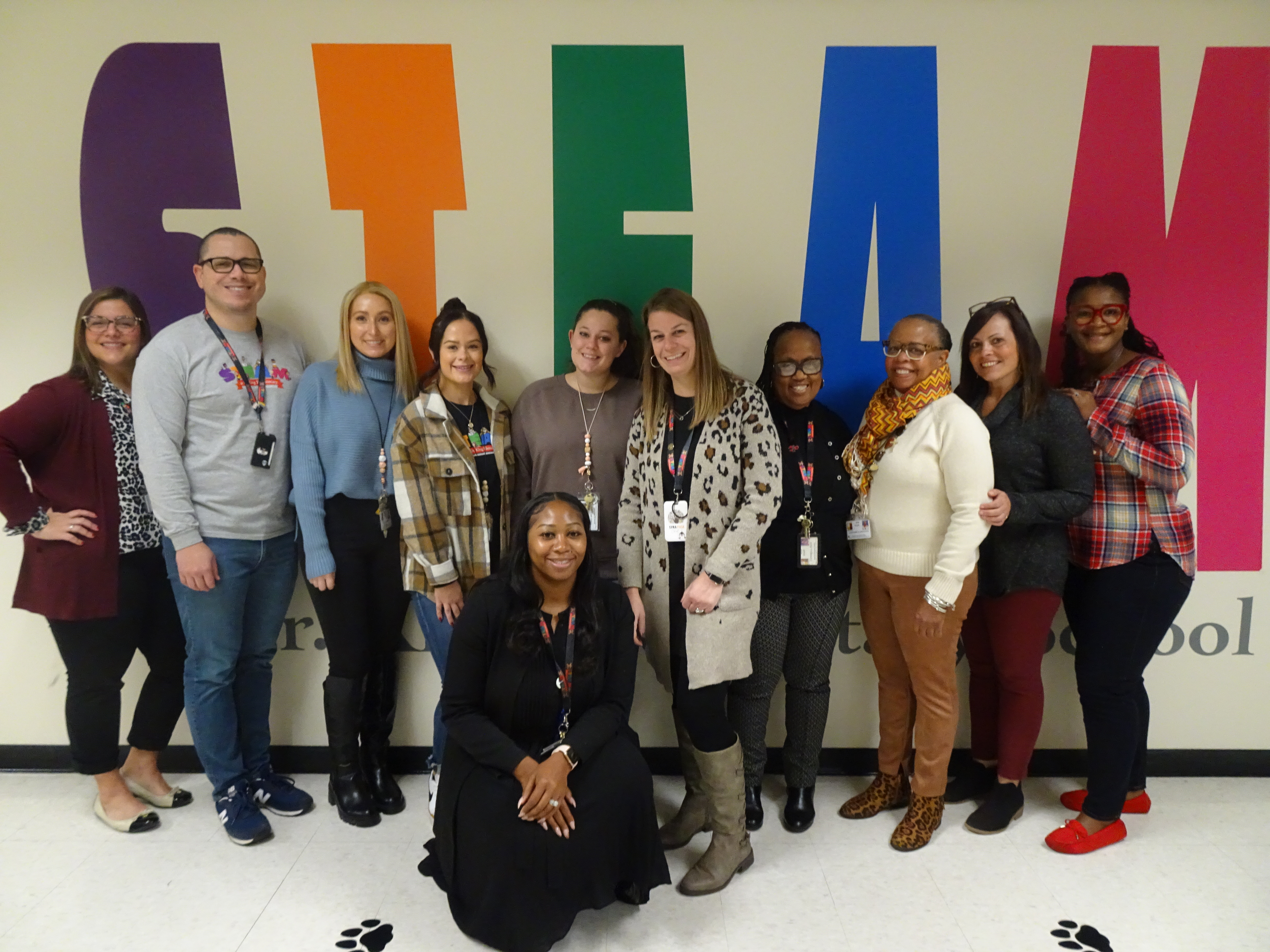 This is a photo of the Equity Team at STEAM at Dr. King, smiling at the camera.