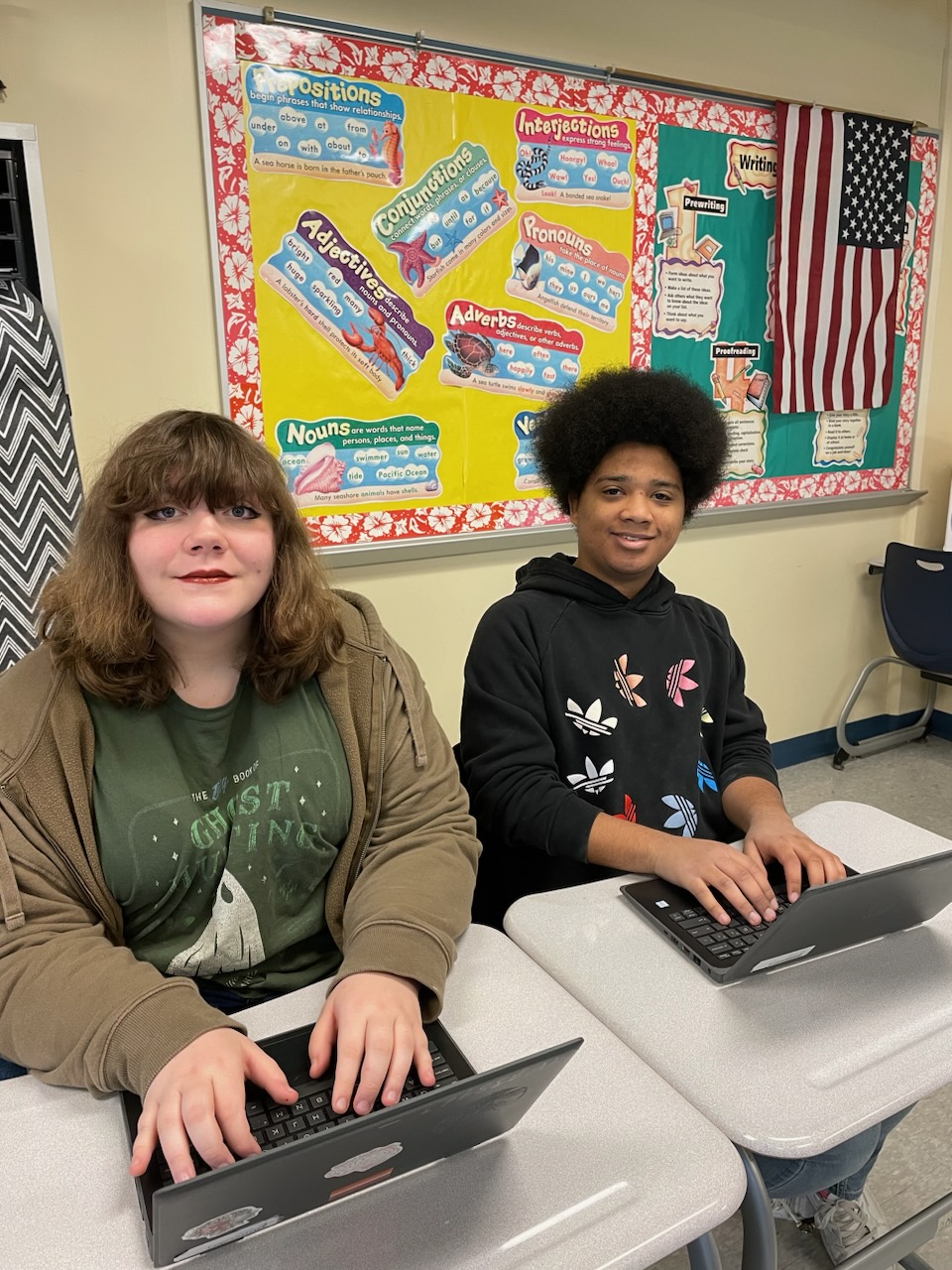 This is a photo of two students sitting at their computers in an ITC classroom.