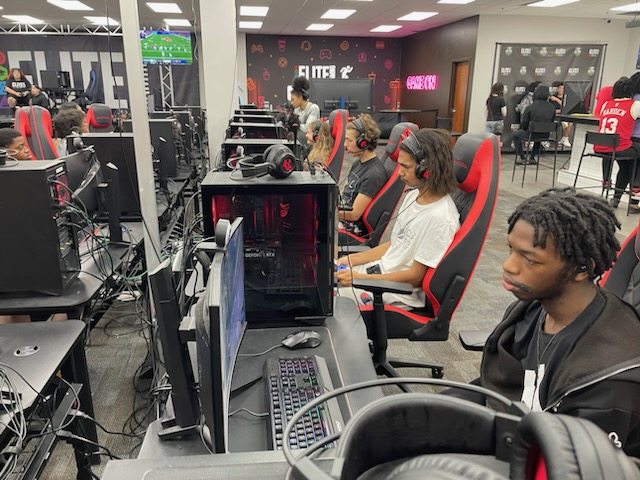 This is a photo of students sitting at gaming computers at the Elite Gaming headquarters.