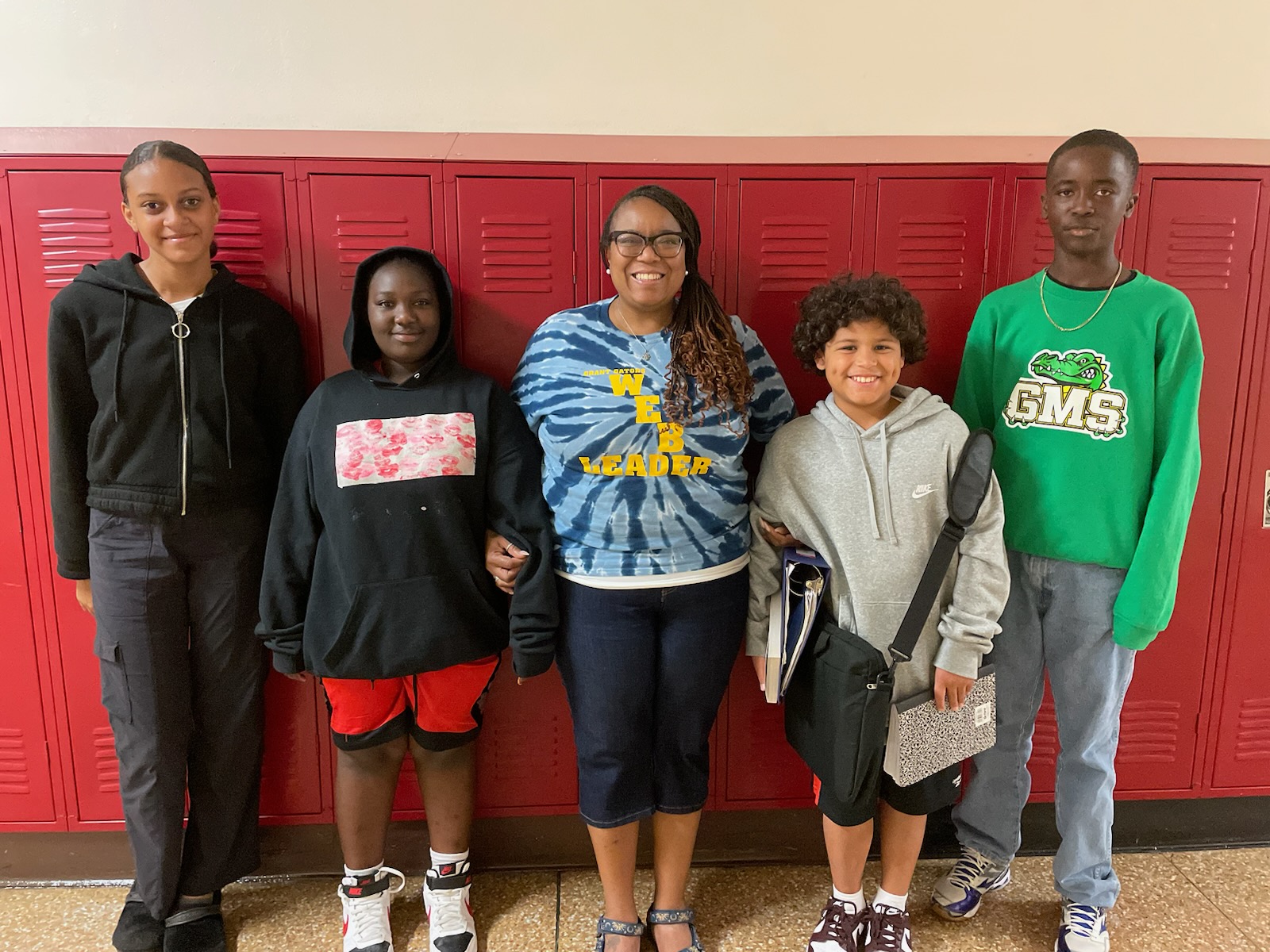 This is a photo of two Grant WEB leaders, smiling alongside two Grant 6th graders and a WEB advisor.