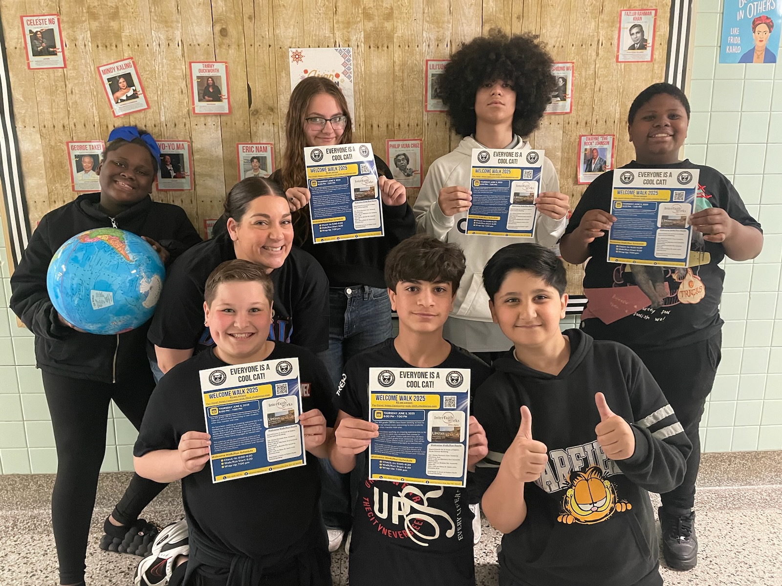 This is a photo of Salem Hyde students holding a flyer for their fundraising walk and smiling at the camera.