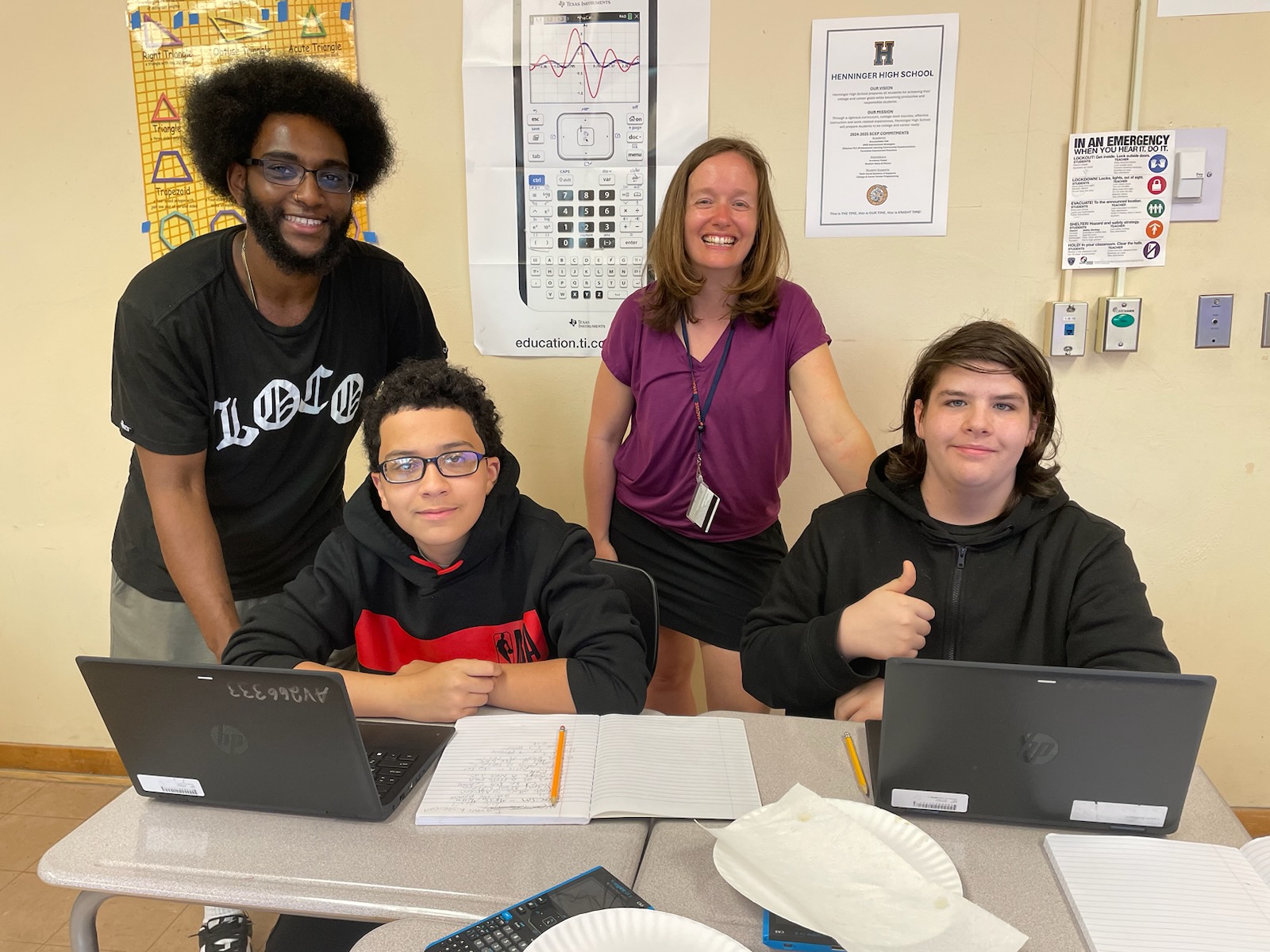 This is a photo of two Henninger Data Warriors students and their advisors, smiling at the camera.