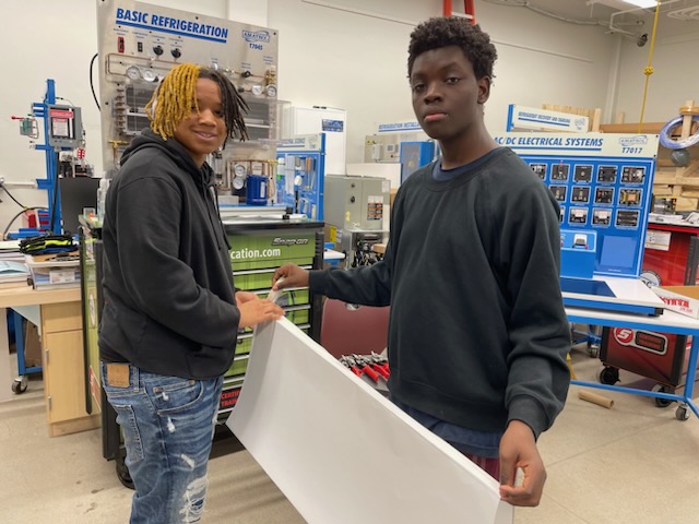 This is a picture of two Corcoran HVAC students standing in their classroom.