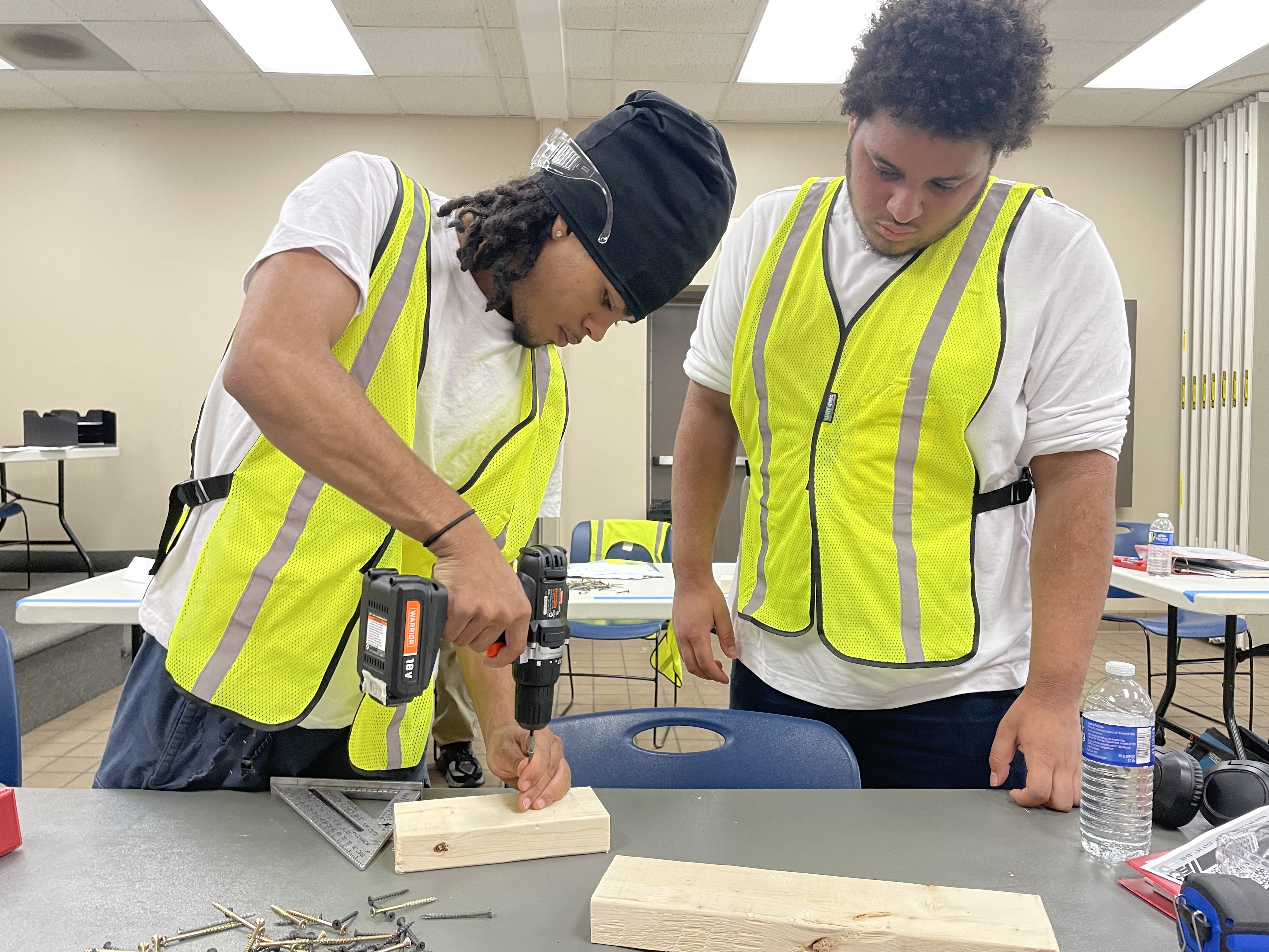 This is a photo of two students practicing a drilling exercise as part of the Pathways to Apprenticeship summer program.