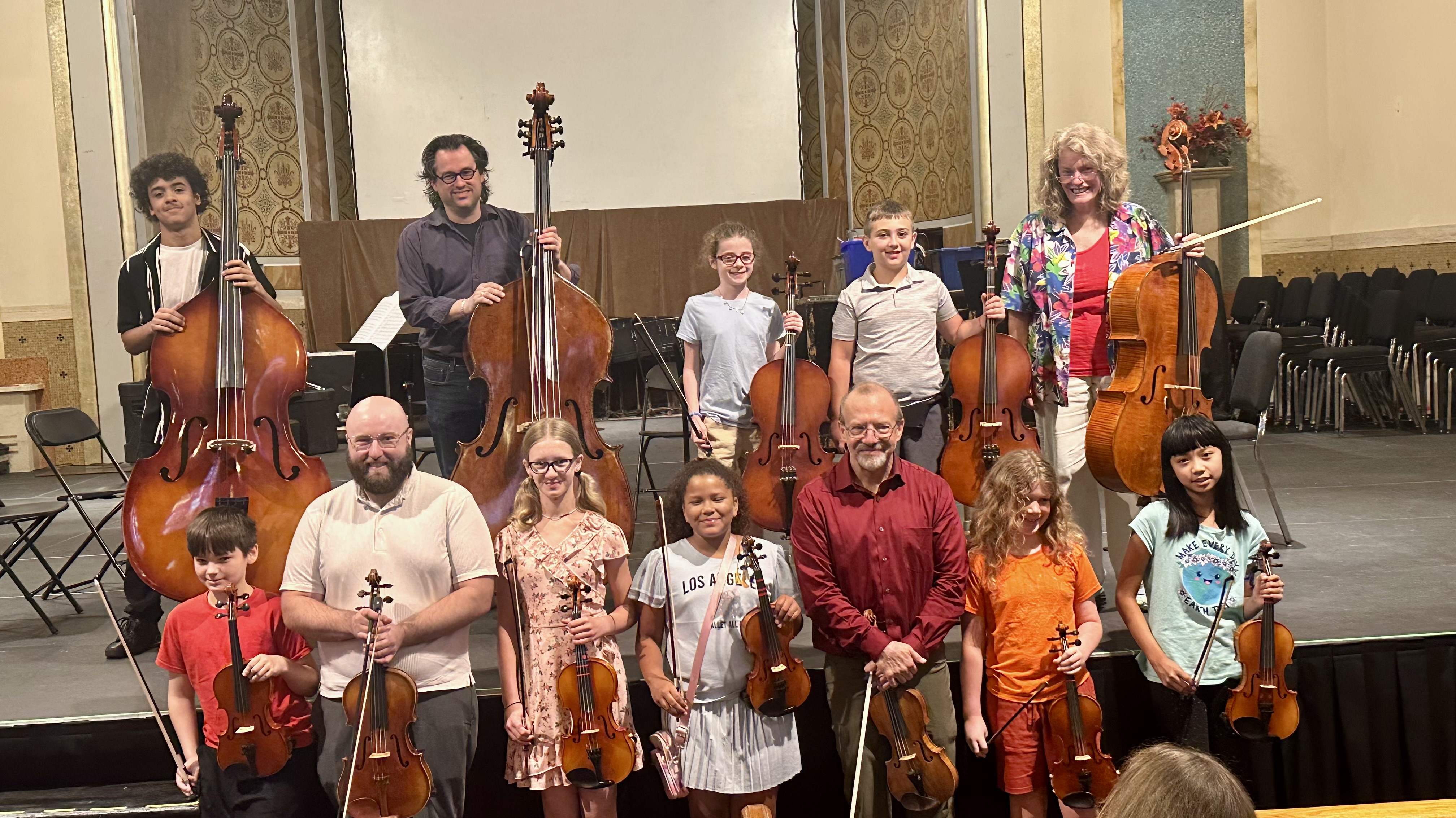 This is a photo of SCSD students along with the Syracuse Symphony members they worked with this summer.