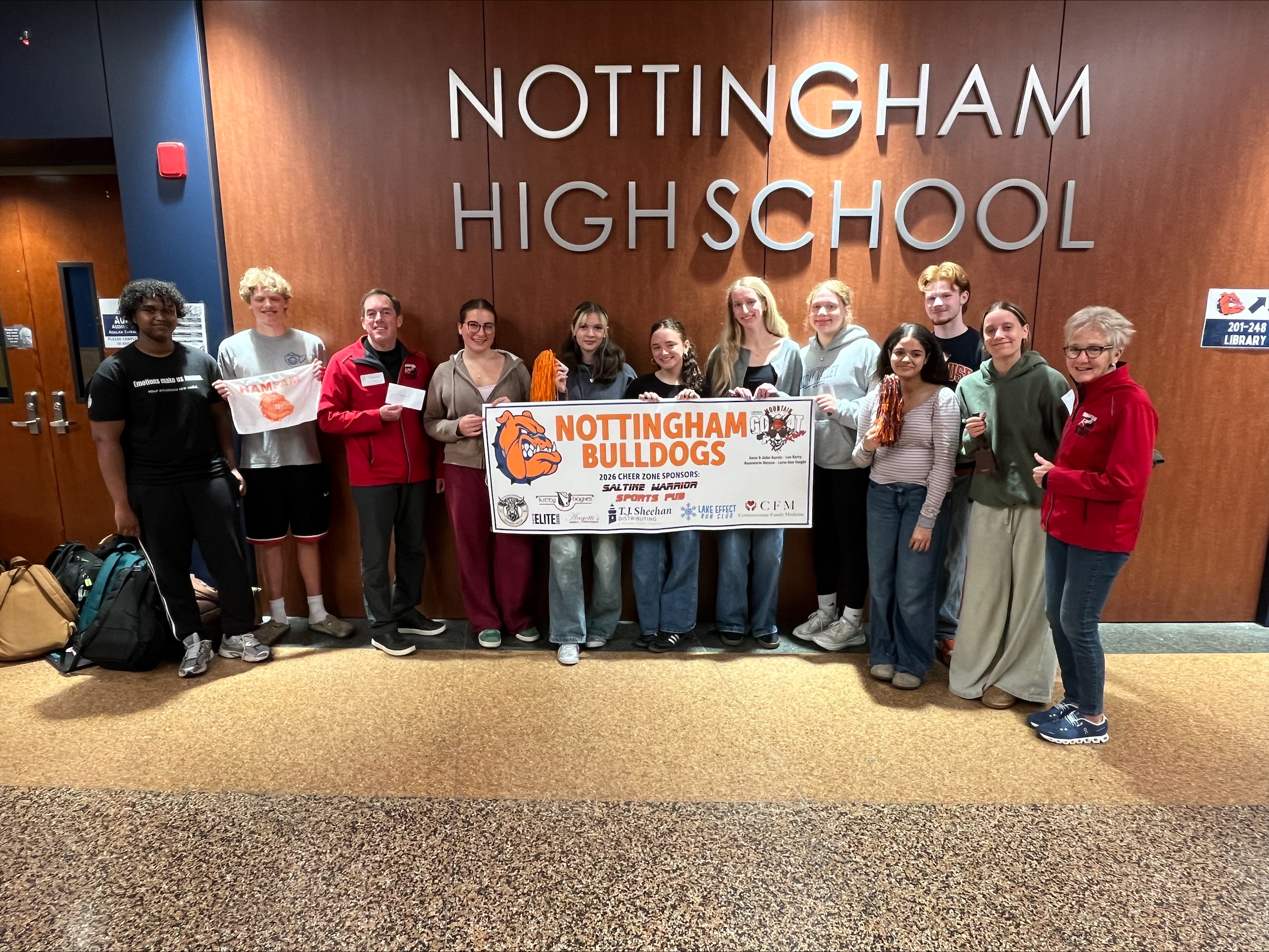This is a photo of Nottingham students holding a banner of congratulations.