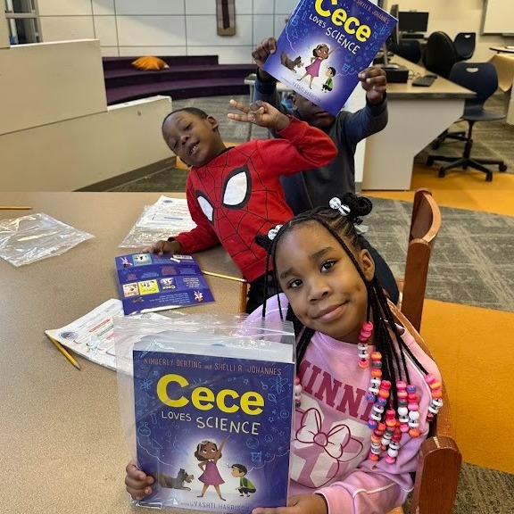 This is a photo of two Dr. Weeks students holding up the books they received.